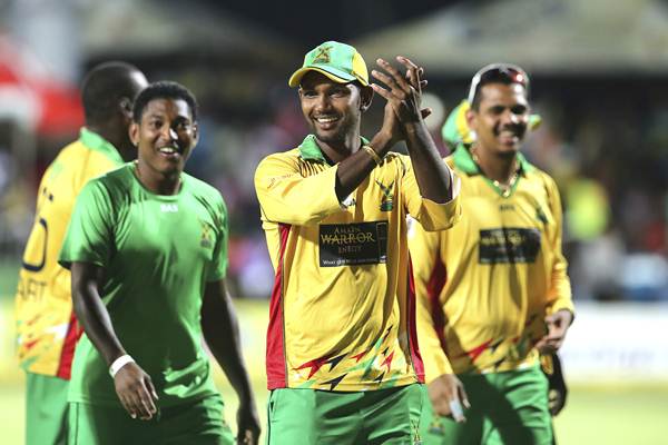 BASSETERRE, ST. KITTS AND NEVIS - AUGUST 14: Denesh Ramdin (C) Krishmar Santokie (L) and Sunil Narine (R) celebrate winning over the Jamaica Tallawahs by 10 wickets during the Semifinal match between Jamaica Tallawahs and Guyana Amazon Warriors as part of the Limacol Caribbean Premier League 2014 at Warner Park on August 14, 2014 in Basseterre, St. Kitts and Nevis. (Photo by Ashley Allen/LatinContent/Getty Images)